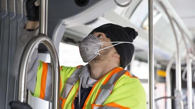 Tyler Goodwin, a utility service worker for King County Metro, deep cleans a metro bus as part of its usual cleaning routine. Getty Images AFP