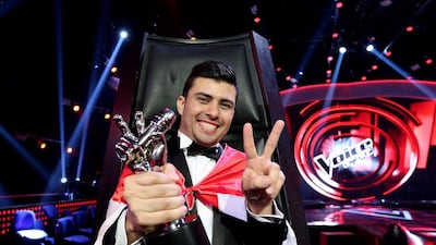 Sattar Saad from Iraq poses with his trophy after winning The Voice. Courtesy Anwar Amro / AFP Photo