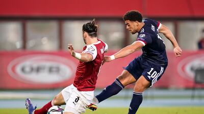 Che Adams of Scotland shoots whilst under pressure from Aleksandar Dragovic of Austria. Getty Images