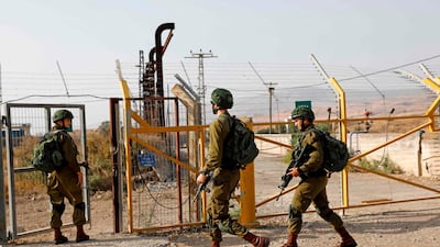 Israeli soldiers patrol the border fence. AFP
