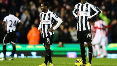 Newcastle's Vurnon Anita and Demba Ba look on as Stoke celebrate Cameron Jerome's goal at the Britannia Stadium.