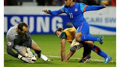 Australia goalkeeper Mark Schwarzer saves from India's Clifford Rayes Miranda. Pornchai Kittiwongsakul / AFP