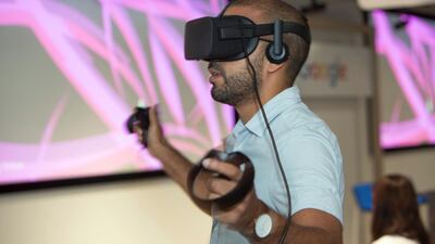 Artist El Seed tries interactive VR goggles at the Google Ramadan Breakfast in Dubai. Leslie Pableo for The National