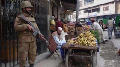 A Pakistan army soldier stands alert at a bazaar in Mingora, the main town of Pakistan's troubled Swat Valley.