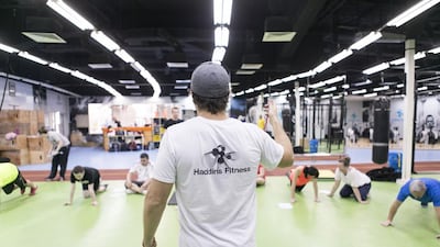 Michael Haddin, the managing director of Haddins Fitness, drills participants. Reem Mohammed / The National