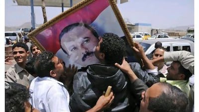 Supporters of Yemeni President Ali Abdullah Saleh kiss his portrait as they celebrate news that Saleh's health is stable, after being taken to Saudi Arabia to receive medical treatment for wounds he suffered in a rocket attack on his compound, Mohammed al Sayaghi / AP Photo