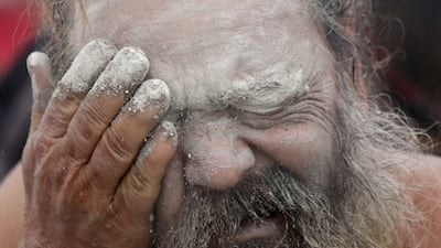 An Indian monk performs the ritual of applying mud dust on his face. EPA