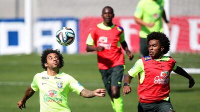 Willian (above, right): The Chelsea winger is one of relatively few new faces in the squad from the side that won the Confederations Cup last year after an impressive first season in England. His versatility to play on either wing or through the middle offers coach Luiz Felipe Scolari flexibility, but his ability to cope with the pressure that Neymar was under is questionable given he failed to even hit the target with his penalty in the agonising shootout win over Chile in the last-16. Marcelo Sayao / EPA