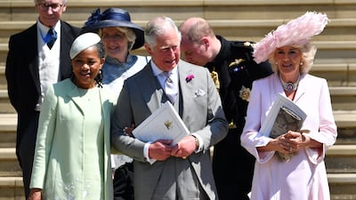 The queen consort, in a pink dress and a feathered hat, with Meghan's mother Doria Ragland and King Charles, leaves St George's Chapel in Windsor after the wedding of Prince Harry and Meghan on May 19, 2018. Getty Images