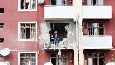 A man looks out from his damaged home after a ceasefire begins during the fighting over the breakaway region of Nagorno-Karabakh in the city of Terter, Azerbaijan. Reuters
