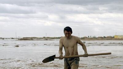 An Afghan man searches for his belongings after flash floods at Jowzjan province in northern Afghanistan. Reuters