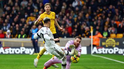 Wolves keeper Jose Sa saves at the feet of United winger Antony. Reuters