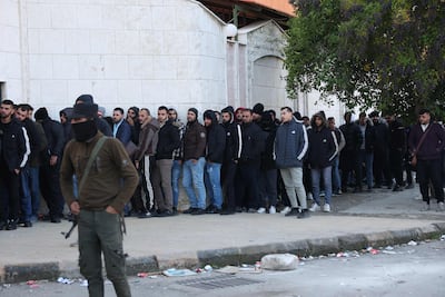 Syrians queue outside a centre in the western port city of Latakia, as members of the former Assad regime register with the rebel authorities to settle their status. AFP