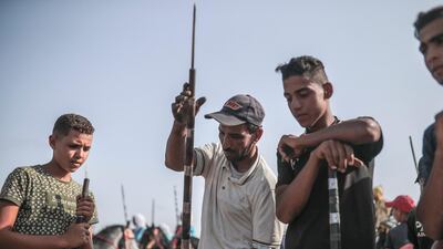 A man helps prepare rifles before being loaded with gunpowder to be used in Tabourida, a traditional horse riding show also known as Fantasia, in the coastal town of El Jadida, Morocco.