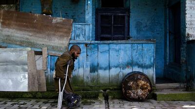 A patient walks past one of the huts.