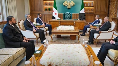 Syrian President Ahmad Al Shara, centre left, discusses strengthening judicial and legal co-operation with chief of Iraq's Supreme Judicial Council Faiq Zaidan, centre right, in Damascus. Sana