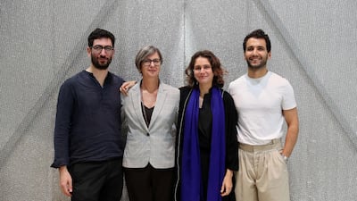 The structure that houses the film by Marysia Lewandowska, second from left, was designed by, from left, Aram Mooradian, Summer Islam and George Massoud of MMI Architects. Pawan Singh / The National