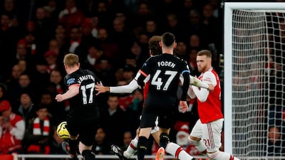 Manchester City midfielder Kevin De Bruyne, left, scores the third goal against Arsenal at the Emirates Stadium in London. AFP