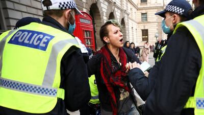 Police officers detain an anti-lockdown protestor during a demonstration amid the coronavirus disease (COVID-19) outbreak in London. Reuters