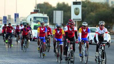 Peter England, chief executive of RAK bank (front left), rides with his employees in Ras Al Khaimah as part of last year’s #cycletoworkuae campaign. Pawan Singh / The National