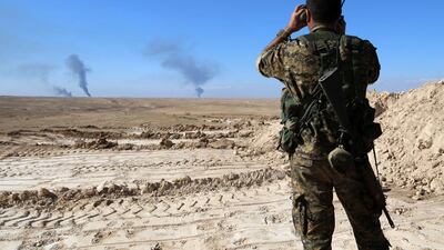 A member of a coalition force monitors the horizon in Al Hol in the Syrian Hasakeh province, some 650 kilometres northeast of Damascus, near the Iraqi border. Delil Souleiman/AFP Photo