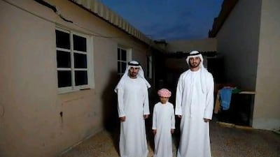 (From left): Brothers Abdullah Alhebsi, 26, Sultan Alhebsi, 8, and Waleed Alhebsi, 29, are photographed in the courtyard of their childhood home in Ras Al Khaimah. Sarah Dea / The National