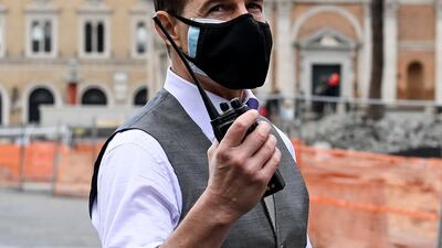 Tom Cruise sports a face mask during the shooting of 'Mission: Impossible 7' at Piazza Venezia in Rome, Italy on November 29, 2020. EPA