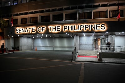 Armed security personnel stand guard at the entrance of the Senate building in Manila. AFP