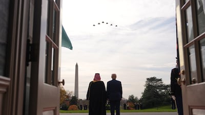 Mr Trump and Prince Mohammed watch an F-35 formation flying overhead during a welcome ceremony. AP