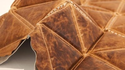 A piece by Zeinab Alhashemi, a camel leather carpet with geometric shapes filled with desert sand. Antonie Robertson/The National)