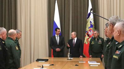 Syrian President Bashar Assad, center left, with Mr Putin and Russian defence minister Sergei Shoigu, centre right, and other Russian military officials. Mikhail Klimentyev / Kremlin Pool Photo via AP