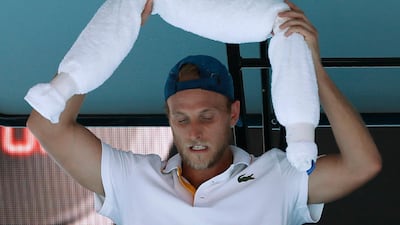 Denis Kudla, who lost to Dominic Thiem, at the Australian Open, puts ice towels around his shoulders during his match. Issei Kato / Reuters
