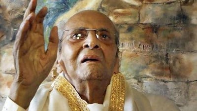 The veteran Bollywood actor Pran in front of a painting of himself at a younger age. AP Photo