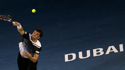 Malek Jaziri serves the ball to Roger Federer at the Aviation Club. Karim Sahib/AFP