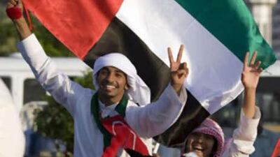 Revellers show their pride during the car parade on the Corniche during the 37th National Day festivities in Abu Dhabi.