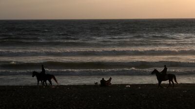People ride horses on the beach during sunset at Ramlet Al Bayda in Beirut. EPA