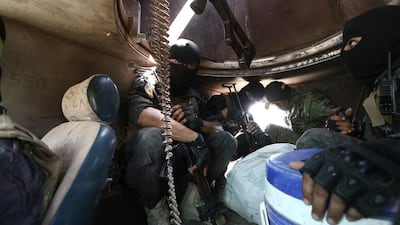 Fighters of the Syria Democratic Forces sit inside a tank near Manbij in Aleppo province on June 25, 2016. Rodi Said / Reuters