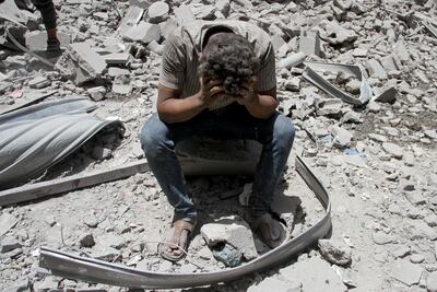 A Palestinian man at the site of Israeli strikes that hit a residential building and destroyed shops at Gaza's Old City market. Reuters