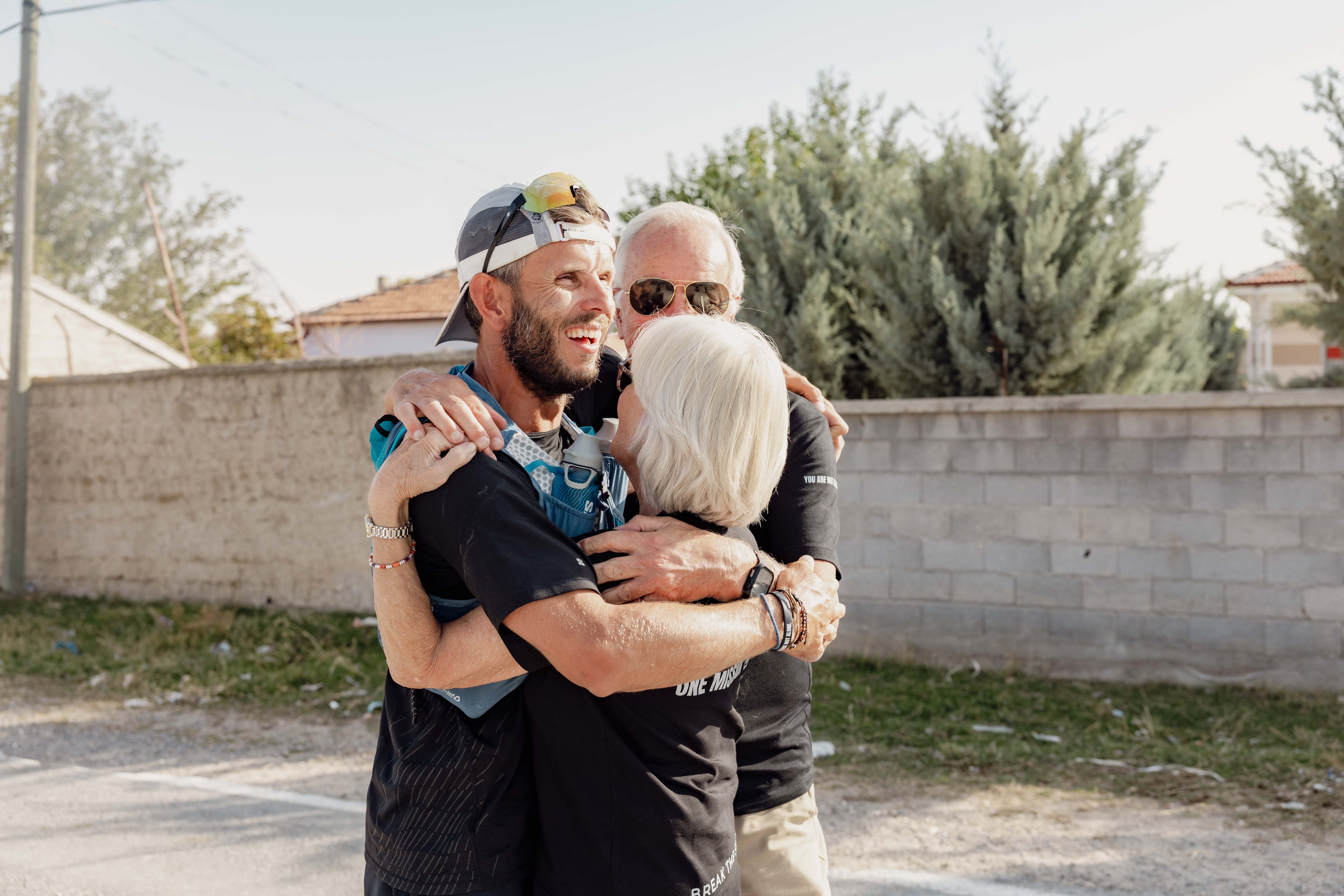 Nick Coats embraces his family at the finish line in Turkey. Photo: Nick Coats