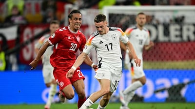 Denmark's forward Yussuf Poulsen and Germany's midfielder Florian Wirtz fight for the ball during the UEFA Euro 2024 round of 16 football match. AFP