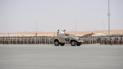Sheikh Hazza bin Zayed, Vice Chairman of the Abu Dhabi Executive Council, Sheikh Hamdan bin Mohammed, Crown Prince of Dubai and Lt Gen Hamad Thani Al Romaithi, Chief of Staff UAE Armed Forces, inspect military personnel during a parade marking 40th anniversary of the UAE Armed Forces unification, and the graduation ceremony for the 5th batch of National Service personnel, at the Seeh Al Hama camp. Rashed Al Mansoori / Crown Prince Court - Abu Dhabi