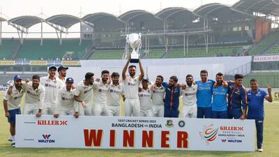 Indian team players with the series trophy after wining second Test against Bangladesh. AP