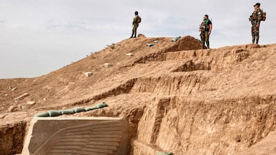 Iraqi security forces stand guard at the site. It had been buried in situ by the Iraqi State Board of Antiquities and Heritage to protect it during the conflict and it has emerged remarkably unscathed. AFP