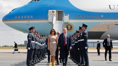 US President Donald Trump and first lady Melania Trump walk across the tarmac after stepping off Air Force One as they arrive at London's Stansted Airport. AP Photo