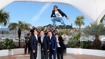 French actor Jamel Debbouze jumps above, from left, actor Tewfik Jallab, director Mohamed Hamidi, French-Algerian actor Fatsah Bouyahmed and French comedian Malik Bentalha as they pose on a photocall for the film "Ne Quelque Part" (Born Somewhere). Loic V???