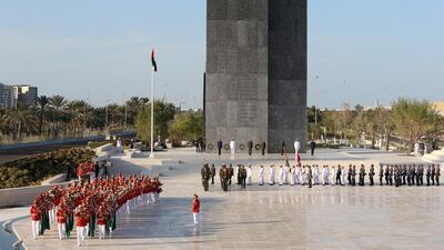 A moment of silence is observed during a Commemoration Day flag raising ceremony at the Wahat Al Karama memorial. Delores Johnson / The National
