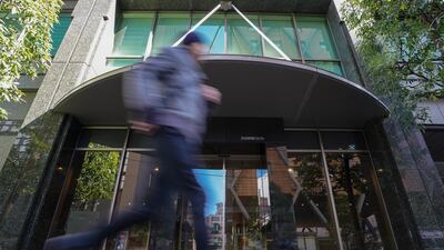 A pedestrian runs past the building where Japan's Coincheck company is located in Tokyo. Christopher Jue / EPA