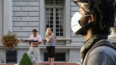 A man and woman draw their firearms on protestors as they enter their neighbourhood during a protest against St. Louis Mayor Lyda Krewson. Reuters
