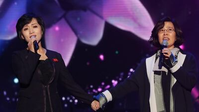 South Korea's Lee Sun-hee, right, and North Korea's Kim Ok-ju, left, sing together during a performance of a joint inter-Korean concert. EPA / Korea Pool