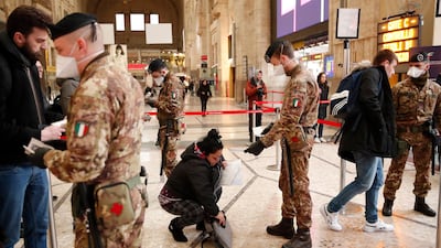 Police officers and soldiers check passengers leaving from Milan main train station, Italy, Monday, March 9, 2020. AP Photo